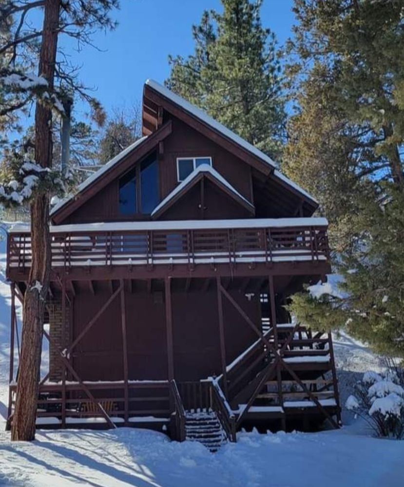 Painted Big Bear cabin exterior in winter snow