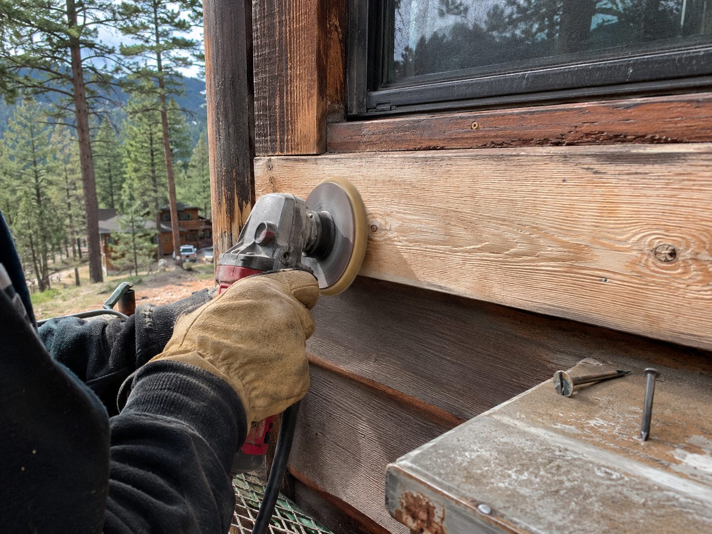Sanding exterior trim down near-bare during prep in Big Bear